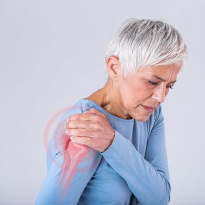 Senior Woman With Shoulder Pain. Elderly Woman Is Enduring Awful Ache. Shoulder Pain In An Elderly Person. Senior Lady With Shoulder Pain